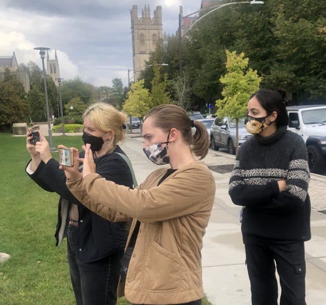 Students engaging with Jenny Holzer's AR art